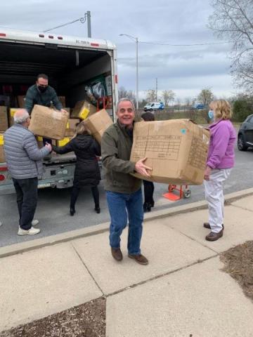 People unloading boxes from a truck